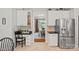 Bright kitchen features a stainless steel refrigerator, a built-in desk, and open access to the dining area at 1400 Coachman Dr, Waxhaw, NC 28173