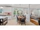 Cozy kitchen nook with a wooden table, black chairs, and views of the outdoors through large windows at 1400 Coachman Dr, Waxhaw, NC 28173