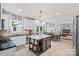 Spacious open-concept kitchen with center island, dining area, and seamless access to the living room at 1400 Coachman Dr, Waxhaw, NC 28173