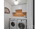 Well-organized laundry room with built-in cabinets, a countertop, and front load washer and dryer at 1400 Coachman Dr, Waxhaw, NC 28173
