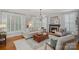 Cozy living room with a fireplace, plantation shutters, hardwood floors, and ample seating at 1400 Coachman Dr, Waxhaw, NC 28173