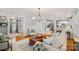 Open-concept living area with hardwood floors, a staircase, and views into the kitchen and dining area at 1400 Coachman Dr, Waxhaw, NC 28173