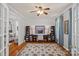 Stylish home office featuring custom built-ins, shiplap accent wall, hardwood floors, and natural light at 1400 Coachman Dr, Waxhaw, NC 28173
