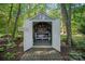 Charming potting shed with open doors and a workbench provides a creative outdoor space at 1400 Coachman Dr, Waxhaw, NC 28173