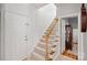Entryway with a carpeted staircase and light wood banister at 1400 Coachman Dr, Waxhaw, NC 28173