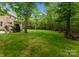 Expansive backyard featuring lush lawn and mature trees offers privacy and serenity at 1410 Smoketree Ct, Waxhaw, NC 28173