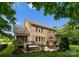 Spacious backyard with a patio area, hot tub, lush greenery, and an outdoor seating area at 1410 Smoketree Ct, Waxhaw, NC 28173