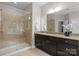 Elegant bathroom with glass enclosed shower, granite countertop and dark wood cabinets at 1410 Smoketree Ct, Waxhaw, NC 28173