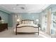 This spacious bedroom has soft blue walls, a tray ceiling and stylish decor at 1410 Smoketree Ct, Waxhaw, NC 28173