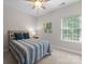 Cozy bedroom features a ceiling fan, neutral walls, and a large window at 1410 Smoketree Ct, Waxhaw, NC 28173