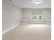 An open bonus room with plush carpet, recessed lighting and one large window at 1410 Smoketree Ct, Waxhaw, NC 28173