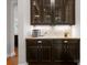The buffet features dark cabinets with glass fronts and granite countertop, and decorative lighting at 1410 Smoketree Ct, Waxhaw, NC 28173