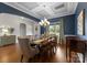 Elegant dining room with hardwood floors, coffered ceiling, and stylish curtains at 1410 Smoketree Ct, Waxhaw, NC 28173
