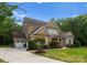 Beautiful brick home with a manicured lawn, attached garage, and a welcoming driveway at 1410 Smoketree Ct, Waxhaw, NC 28173