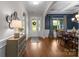 Inviting foyer with hardwood floors, decorative mirror, and elegant entry door with glass accents at 1410 Smoketree Ct, Waxhaw, NC 28173