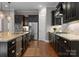 A kitchen showcases dark cabinets, granite counters, stainless steel appliances, and ample counter space for cooking at 1410 Smoketree Ct, Waxhaw, NC 28173