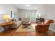A comfortable living room with hardwood floors, neutral furniture, and natural light from the windows at 1410 Smoketree Ct, Waxhaw, NC 28173