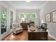 Bright home office with hardwood floors, natural light, and a comfortable workspace at 1410 Smoketree Ct, Waxhaw, NC 28173