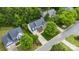 Aerial view showcasing a lovely brick home with lush landscaping and a two car garage at 14849 Middlesborough Dr, Matthews, NC 28104