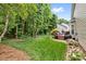 Expansive backyard with lush lawn, mature trees, and a charming deck at 14849 Middlesborough Dr, Matthews, NC 28104