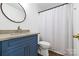 Bathroom features a white toilet, a blue vanity and a granite countertop at 14849 Middlesborough Dr, Matthews, NC 28104