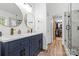 Stylish bathroom with dual sinks, gold fixtures, walk-in shower, and walk-in closet at 14849 Middlesborough Dr, Matthews, NC 28104