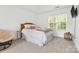 Bedroom with neutral colors, a ceiling fan, and a large window at 14849 Middlesborough Dr, Matthews, NC 28104