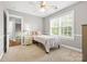 Comfortable bedroom featuring a ceiling fan, large window, and neutral color palette at 14849 Middlesborough Dr, Matthews, NC 28104