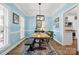 Charming dining room with blue walls, rustic wood table, and stylish light fixture at 14849 Middlesborough Dr, Matthews, NC 28104