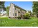 Well maintained yard featuring vinyl siding, a deck and lush landscaping at 14849 Middlesborough Dr, Matthews, NC 28104