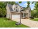 Lovely two-story home features a driveway basketball hoop and attached two car garage at 14849 Middlesborough Dr, Matthews, NC 28104