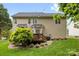 Back of house shows vinyl siding with a deck and lush landscaping at 14849 Middlesborough Dr, Matthews, NC 28104