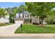 Inviting two-story home with brick accents, manicured lawn, and a basketball hoop at 14849 Middlesborough Dr, Matthews, NC 28104