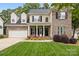 Charming two-story home with brick and siding, manicured lawn, and inviting front porch at 14849 Middlesborough Dr, Matthews, NC 28104