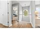 Hallway with wood floors, chandelier, and view to a bedroom at 14849 Middlesborough Dr, Matthews, NC 28104