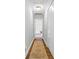Long hallway with hardwood floors and a view to a bedroom at 14849 Middlesborough Dr, Matthews, NC 28104