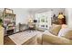 Bright home office with a large window, built-in bookshelves, and comfortable seating at 14849 Middlesborough Dr, Matthews, NC 28104