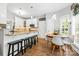 Open-concept kitchen features an island with bar stools and an adjacent breakfast nook at 14849 Middlesborough Dr, Matthews, NC 28104