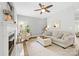 Comfortable living room featuring a fireplace, neutral decor, and plenty of natural light at 14849 Middlesborough Dr, Matthews, NC 28104