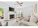 Cozy living room with a fireplace, plush seating, and a view of the outdoor patio at 14849 Middlesborough Dr, Matthews, NC 28104