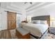 Bright main bedroom featuring a barn door, ceiling fan, bench, and walk-in shower at 14849 Middlesborough Dr, Matthews, NC 28104