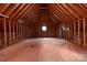 Unfinished attic space with a circular window, exposed beams, and a wood floor at 1504 Alydar Ct, Waxhaw, NC 28173