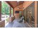 Covered back porch with stone columns, ceiling fans, an outdoor TV, and outdoor seating at 1504 Alydar Ct, Waxhaw, NC 28173