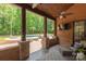 Covered back porch with stone columns, ceiling fans, an outdoor TV, and views of the pool and outdoor kitchen at 1504 Alydar Ct, Waxhaw, NC 28173