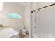 Bathroom featuring a tub-shower combo, earth-tone floors, and a single-sink vanity at 1504 Alydar Ct, Waxhaw, NC 28173