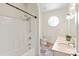 Bathroom with a tub-shower combo, patterned floors, a dual-sink vanity, and a round window at 1504 Alydar Ct, Waxhaw, NC 28173