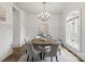Bright dining room with elegant chandelier, round table, and wainscoting at 1504 Alydar Ct, Waxhaw, NC 28173
