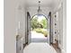 Elegant foyer featuring an arched doorway with black french doors and a view of the landscaped front yard at 1504 Alydar Ct, Waxhaw, NC 28173