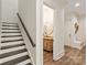 Hallway with stairs leading up, a half-bath, and access to the front entrance at 1504 Alydar Ct, Waxhaw, NC 28173
