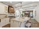 Open kitchen with stone countertops, a copper range hood, and a spacious island at 1504 Alydar Ct, Waxhaw, NC 28173